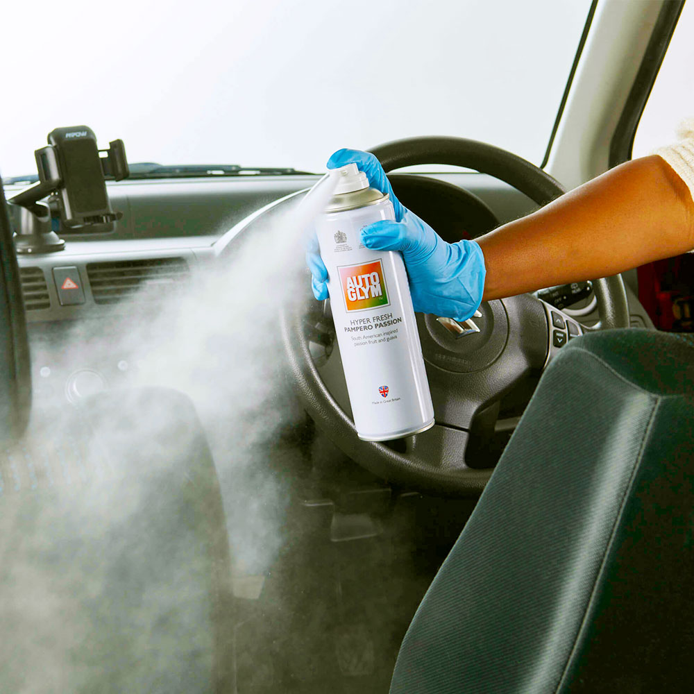 spraying autoglym hyper fresh inside car