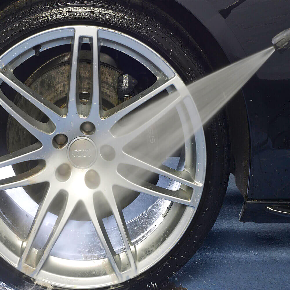 rinsing car wheel with water