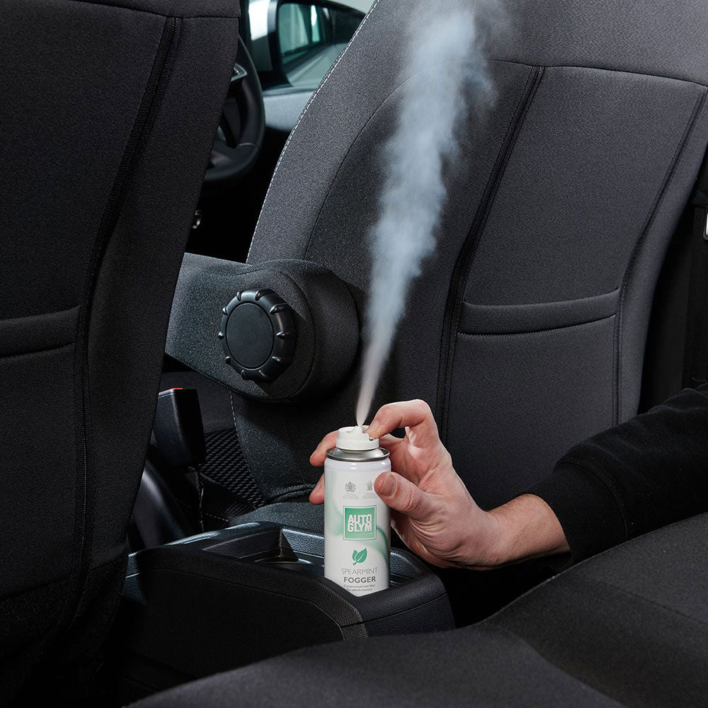 hand on Autoglym Spearmint Fogger inside car