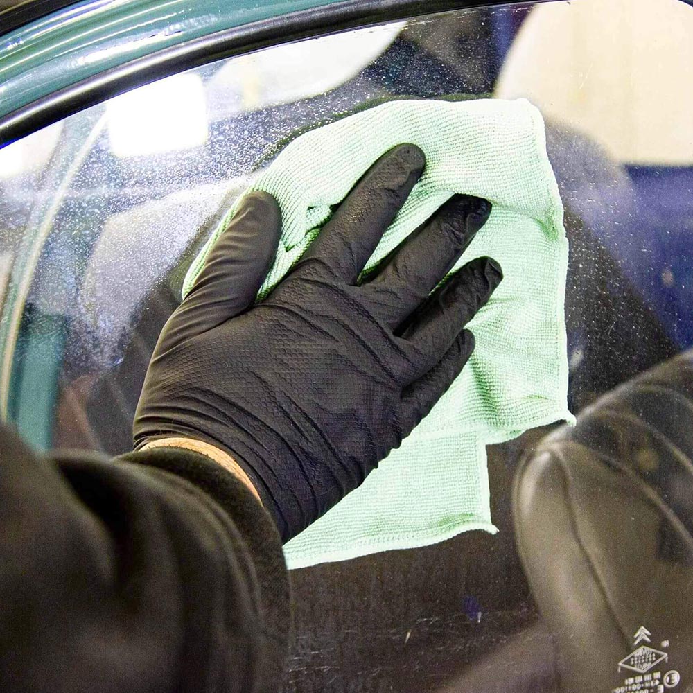 cleaning car window with microfibre cloth and Autoglym Fast Glass