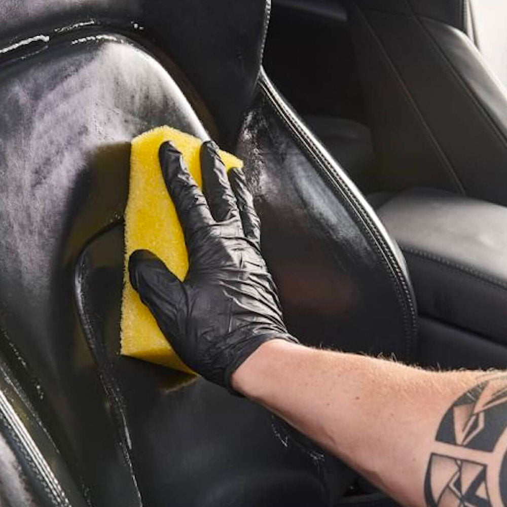 wiping Autoglym Interior Cleaner with sponge on car seat