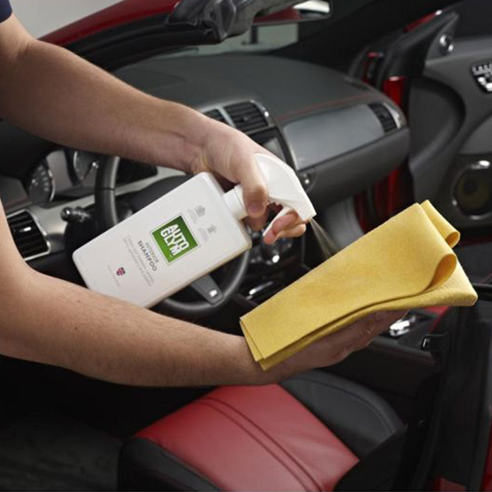 spraying Autoglym Interior Shampoo onto soft cloth
