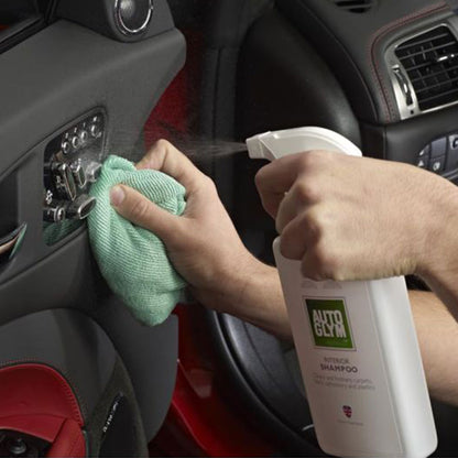 spraying Autoglym Interior Shampoo onto car interior