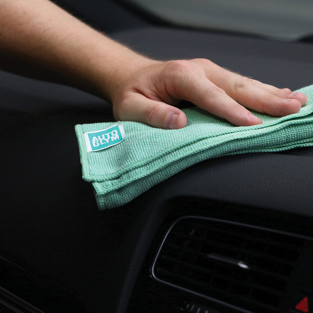 close up of hand holding autoglym interior microfibre inside car
