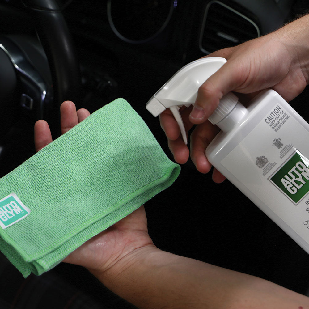 spraying interior shampoo onto Autoglym interior microfibre cloth