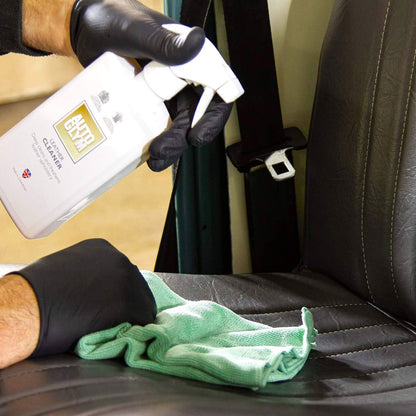 spraying Autoglym Leather Cleaner onto car seat