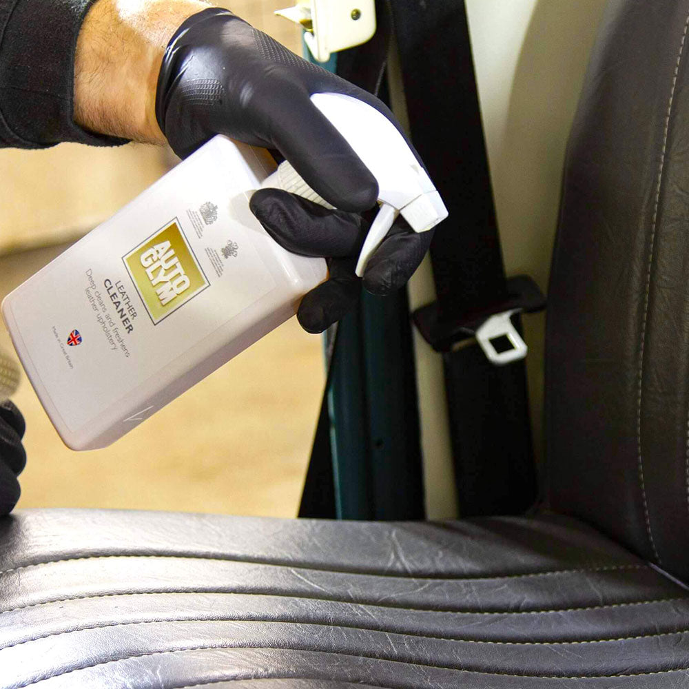 spraying Autoglym Leather Cleaner onto car seat