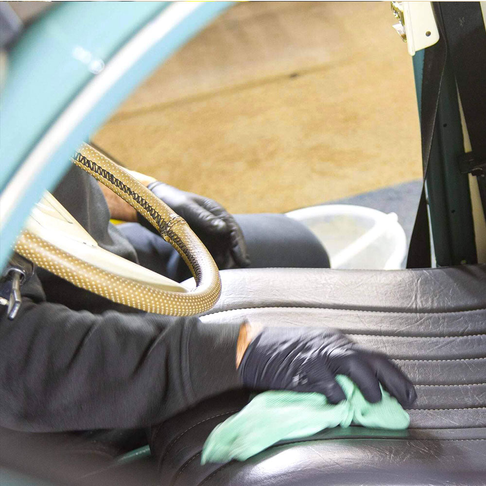 wiping car leather seat with microfibre cloth