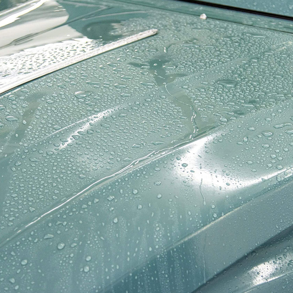 close up water beading off car body