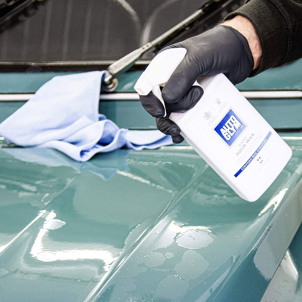 spraying Autoglym Rapid Aqua Wax onto car body