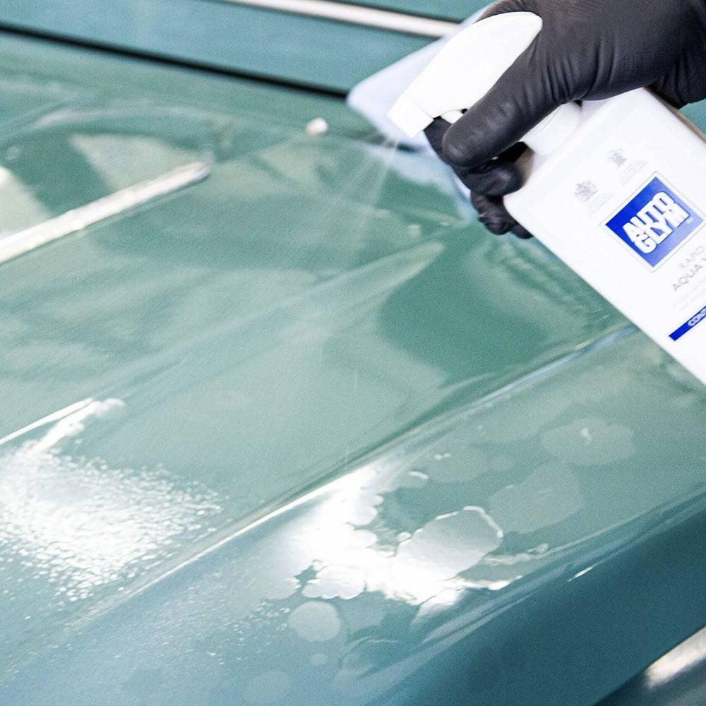 spraying Autoglym Rapid Aqua Wax onto car body