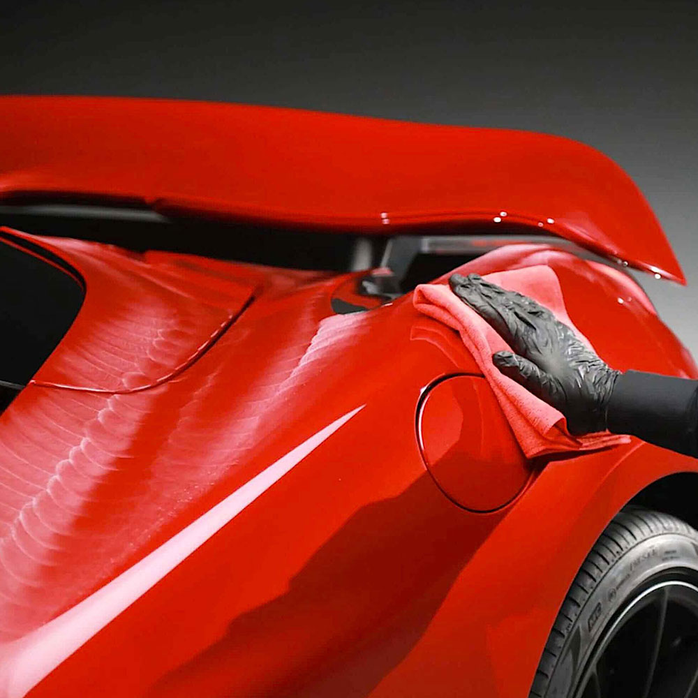 polishing Autoglym Ultra High Definition Wax on red car body
