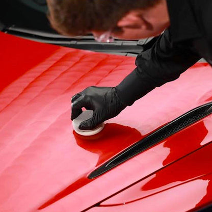 applying Autoglym Ultra High Definition Wax on red car body