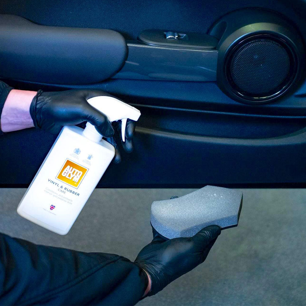 spraying Autoglym Vinyl Rubber Care onto sponge