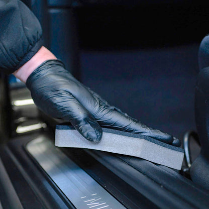 wiping car interior with Autoglym Vinyl Rubber Care on sponge