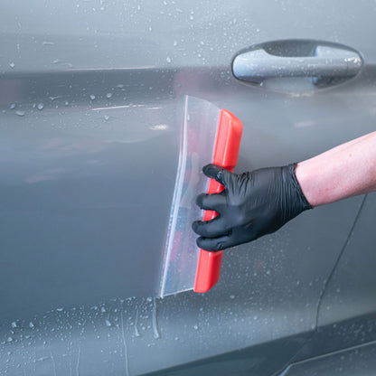 close up of Autoglym Water Blade scraping water off car