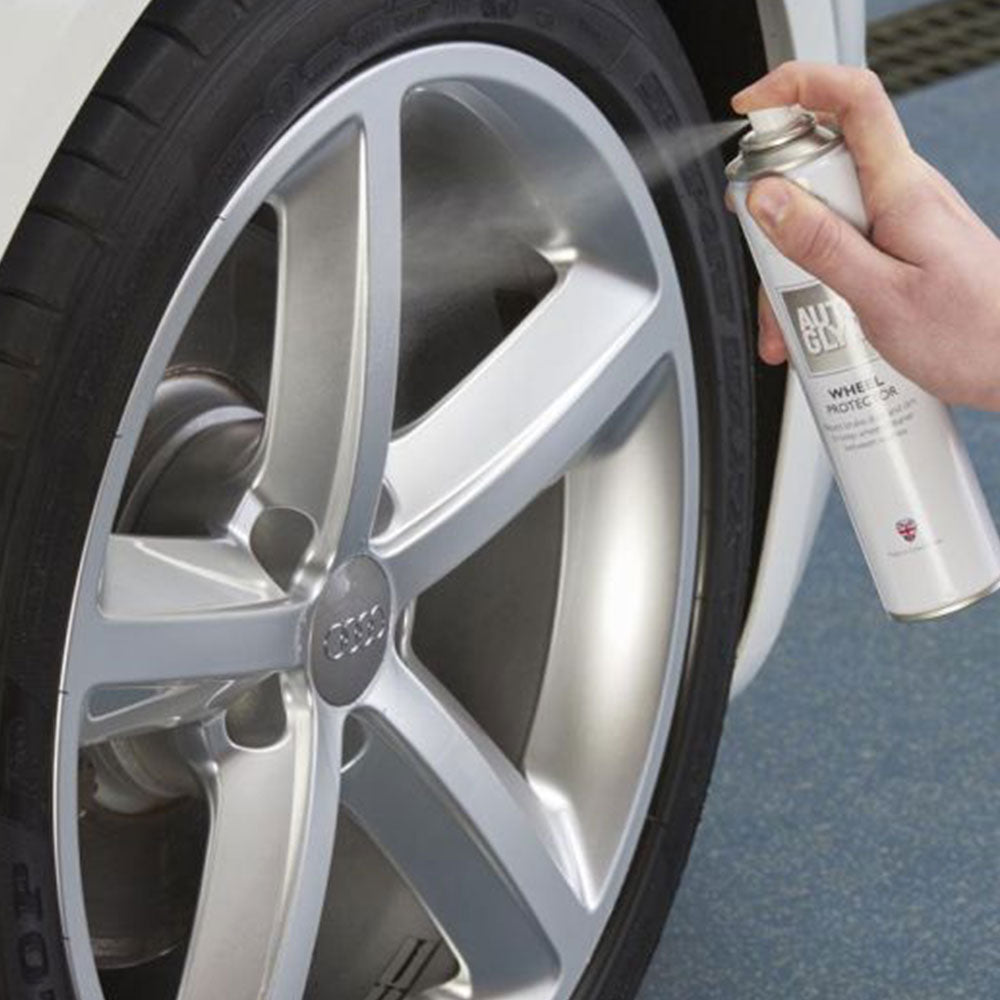 spraying Autoglym Wheel Protector onto car wheel