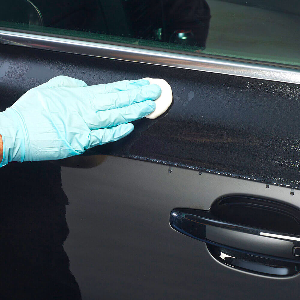 wiping Autoglym Fast Shine and Lube on car