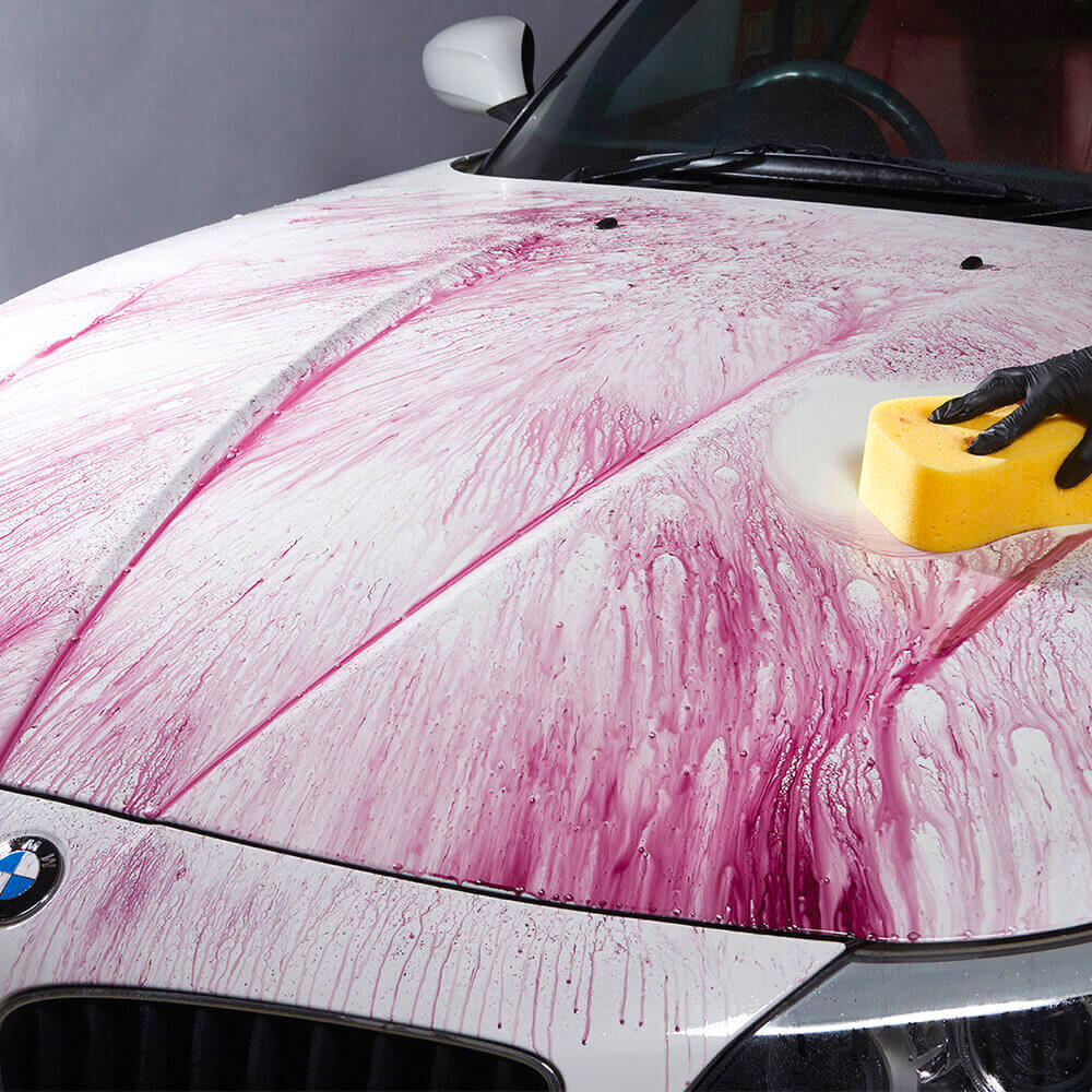 wiping autoglym liquid clay with sponge on car