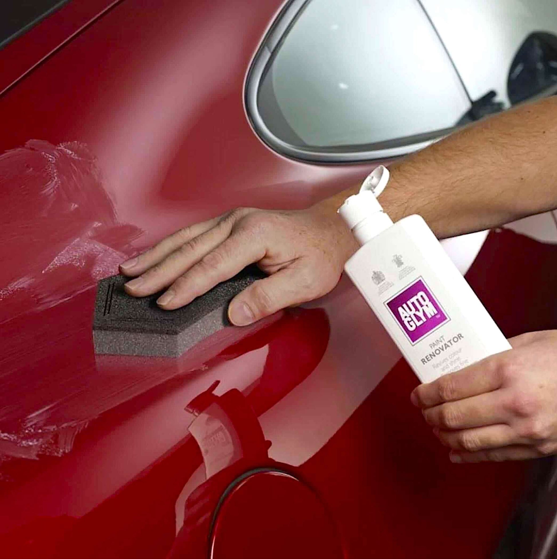 applying Autoglym Paint Renovator with sponge to car body