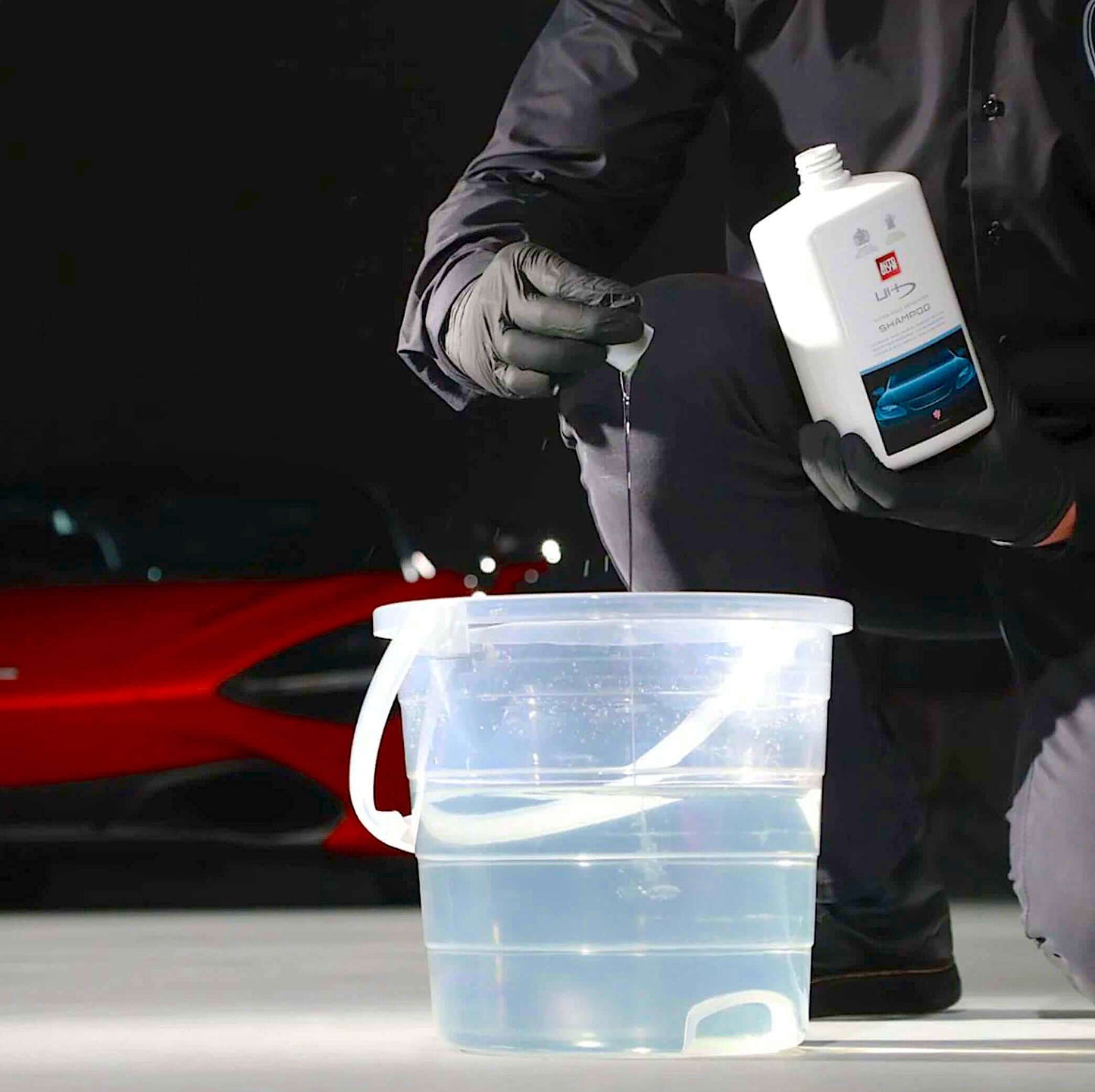pouring Autoglym Ultra High Definition Shampoo into bucket
