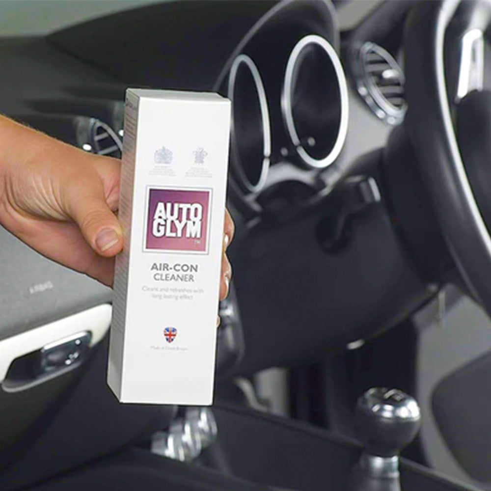 hand holding Autoglym air con cleaner inside car