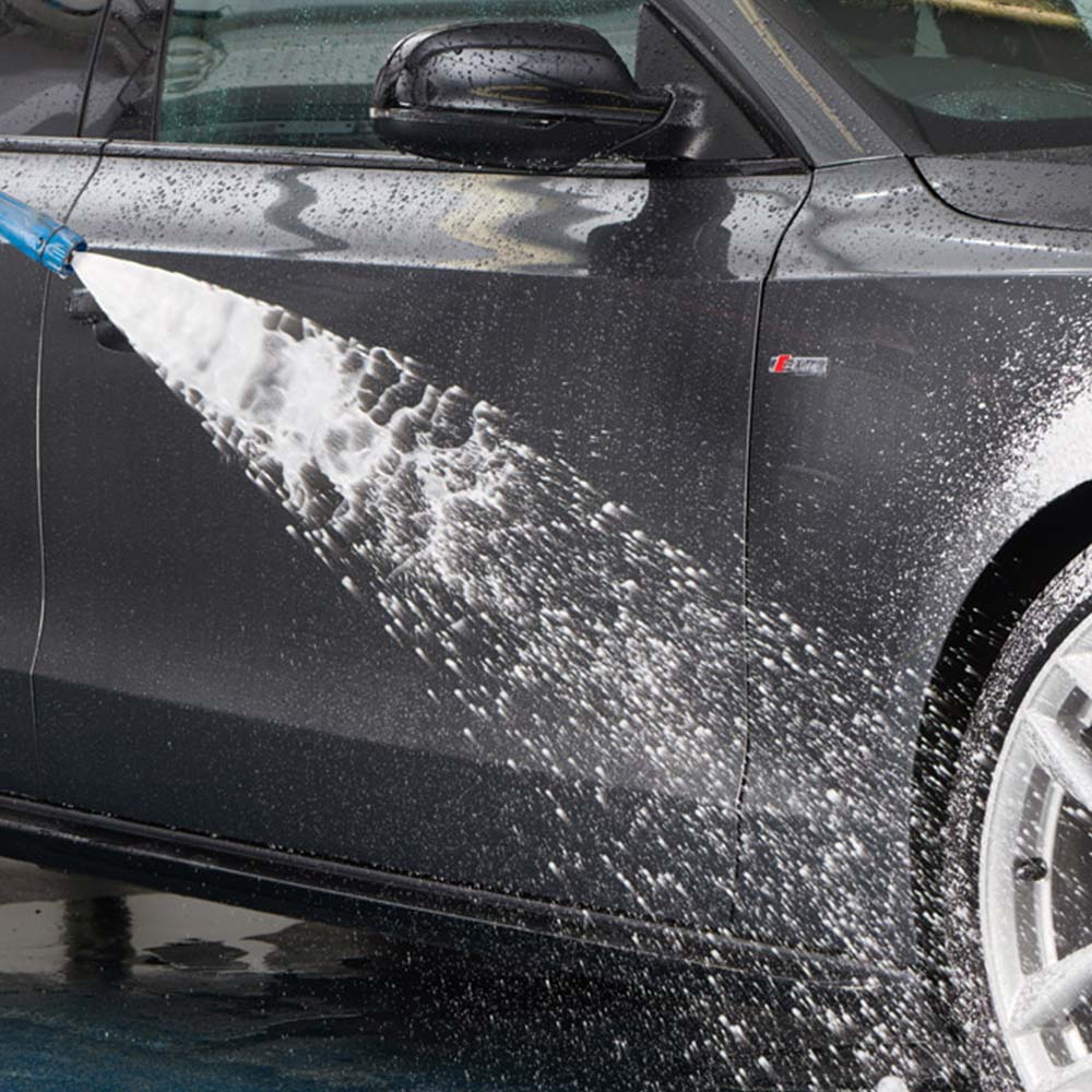 rinsing clean car wheels with hose