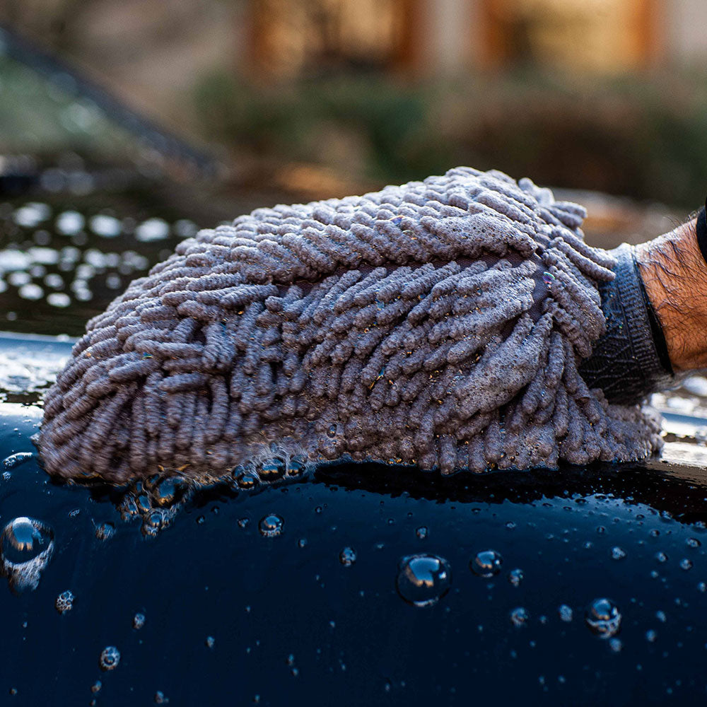 close up of soft mit cleaning car with autoglym bodywork shampoo conditioner