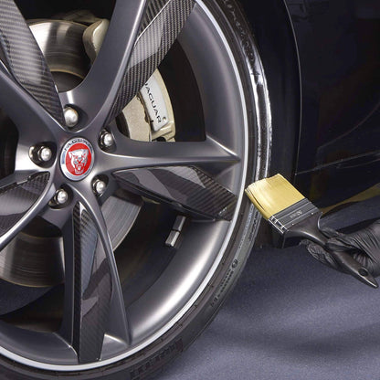applying autoglym high gloss with brush on car tyre