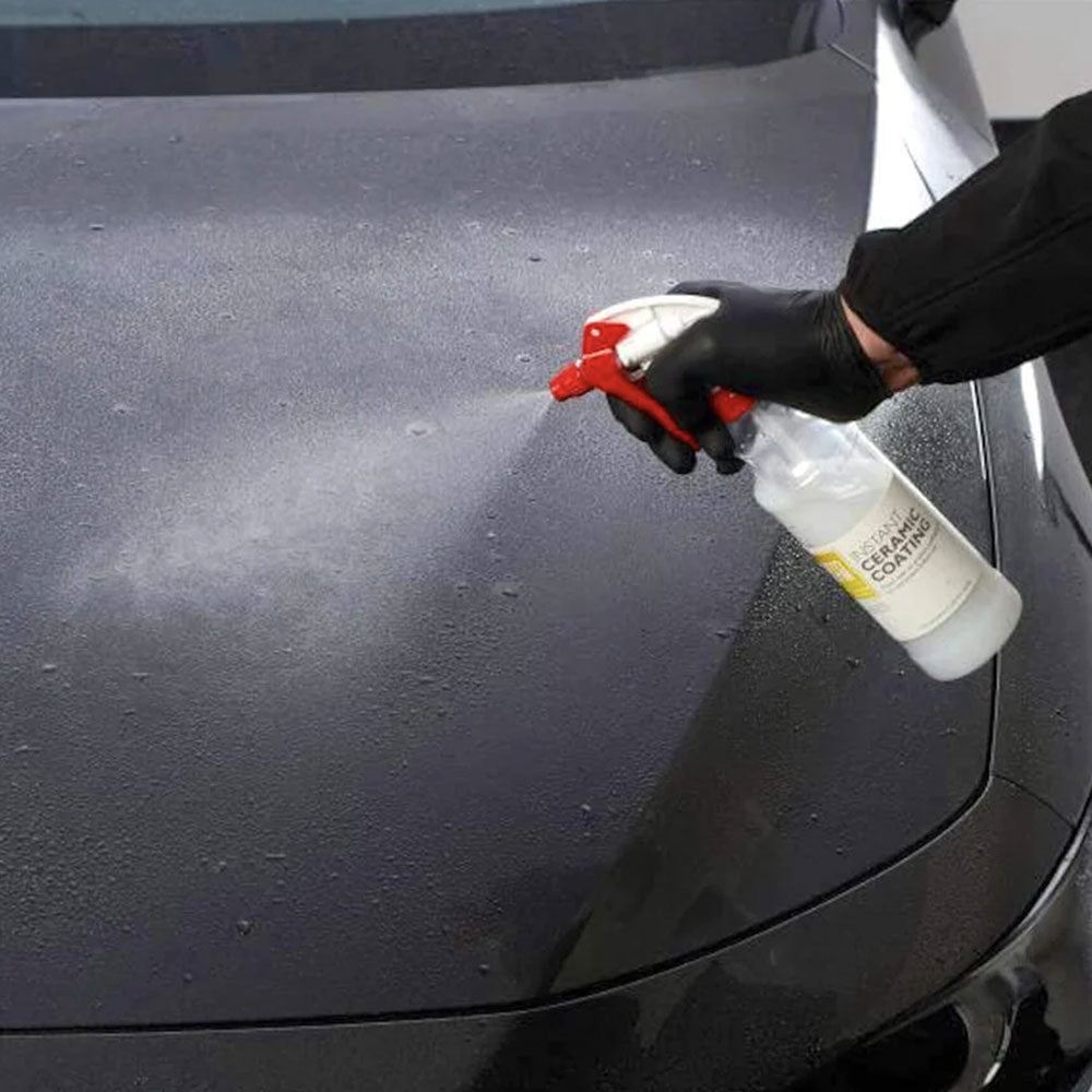 spraying autoglym instant ceramic coating on car exterior