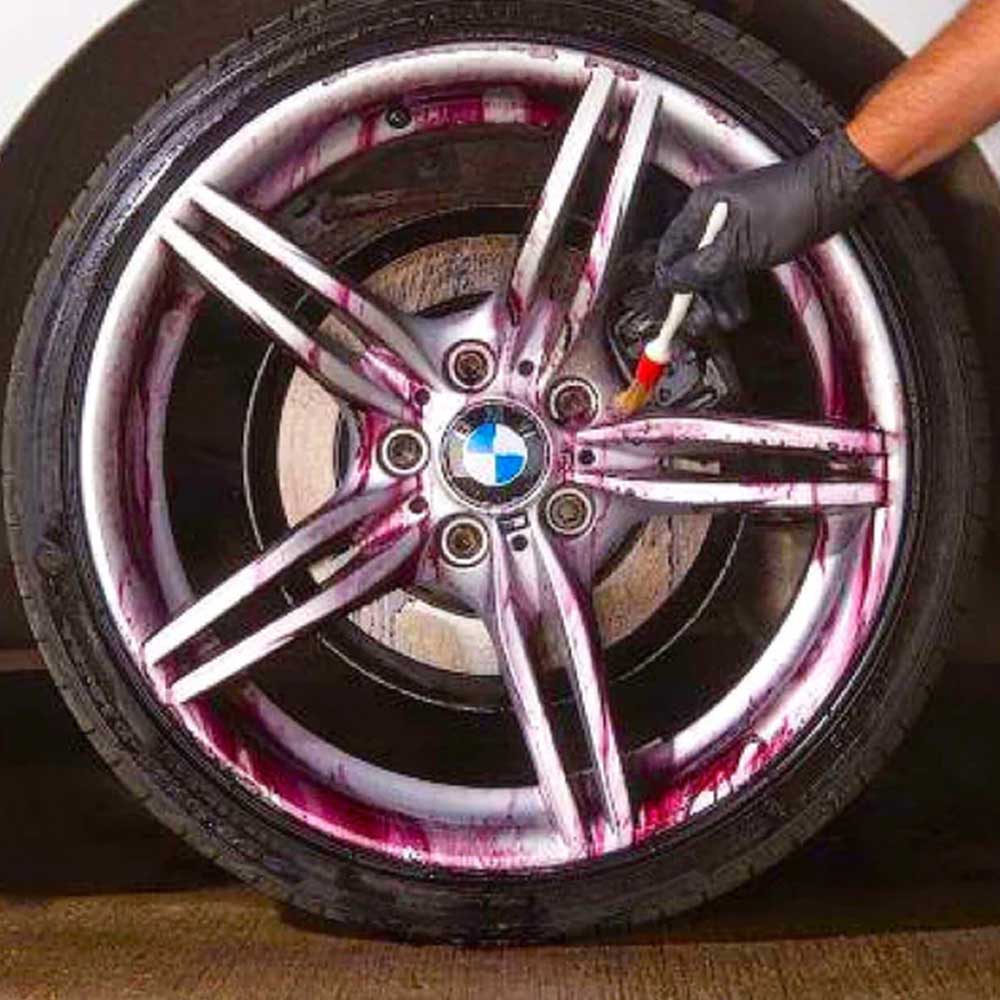 cleaning car wheel with brush